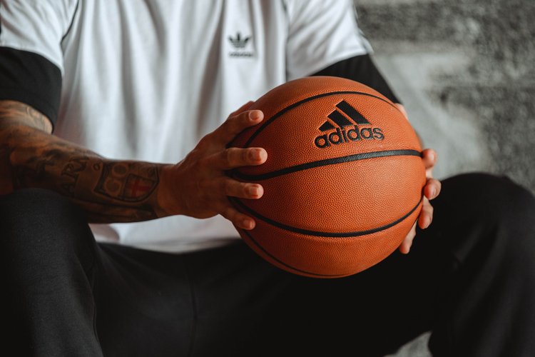 Adidas Basketball in hands of model