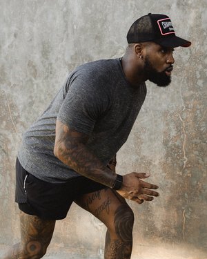Black male athlete getting ready to sprint