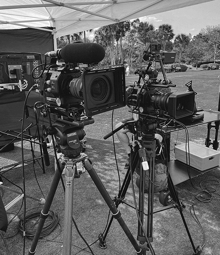 Monochrome image of camera and tripod.