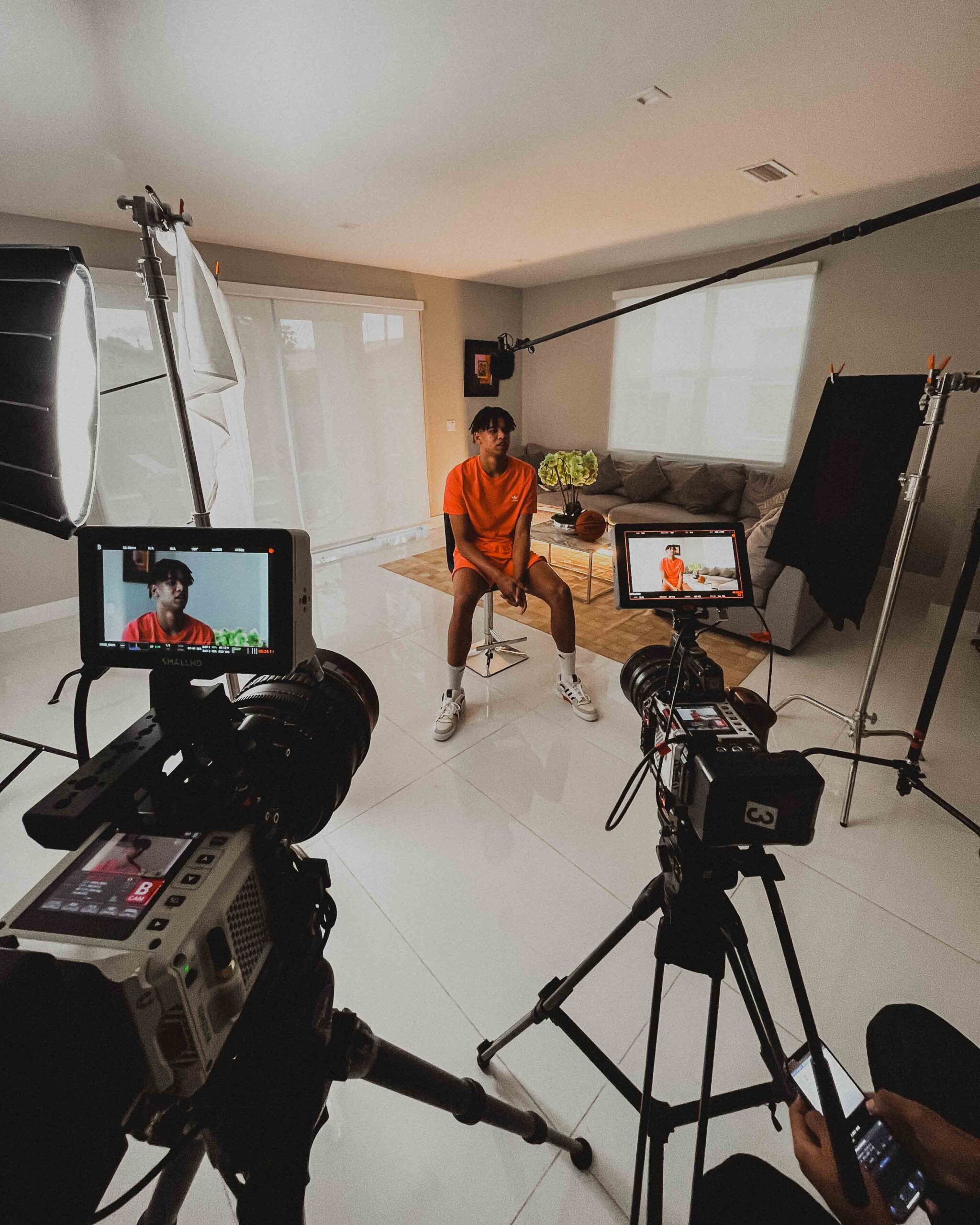 Basketball NBA player, Ousamne Dieng, in a living room, facing a camera for a video recording production for Adidas.