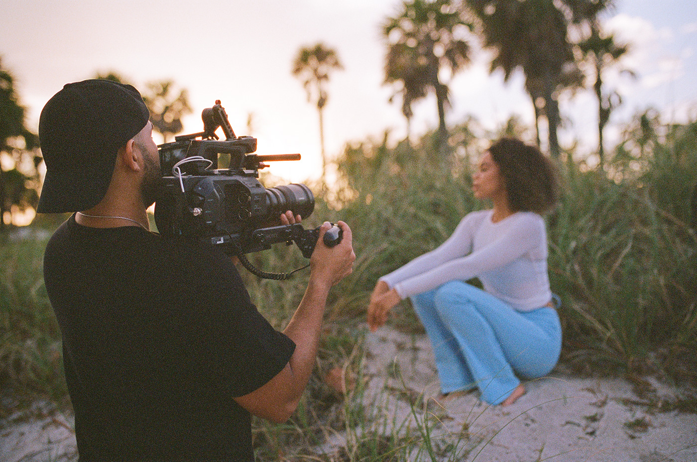 Behind the Scenes of a video production shoot on the beach with model
