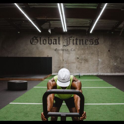 Marlon N. Humphrey of the NF, cornerback for the Baltimore Ravens, training and pushing weight sled in gym