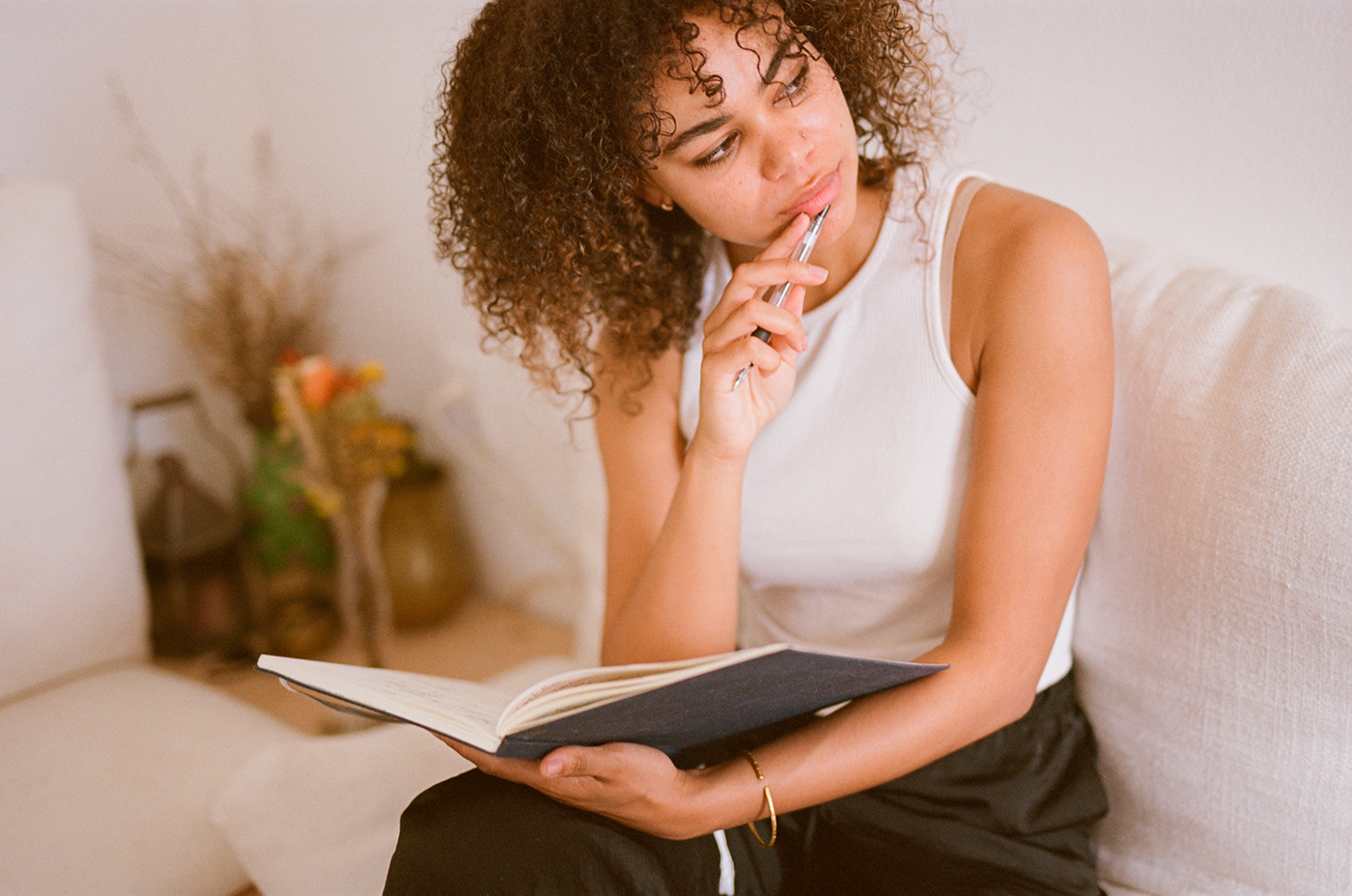 Female model thinking and journaling in the morning