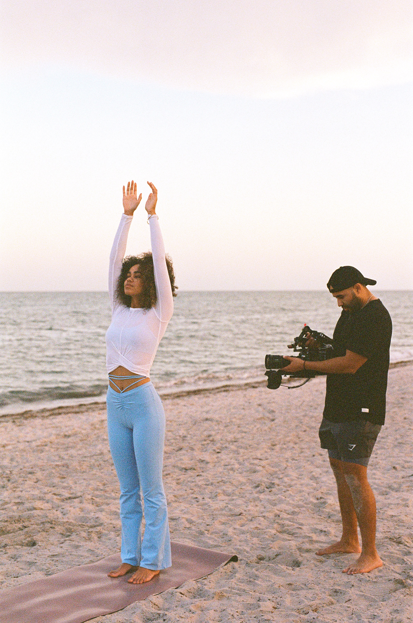 Behind the Scenes of a video production shoot on the beach with model